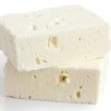 Greek feta cheese block isolated on white.