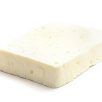 A slab of feta cheese, isolated on a white background.